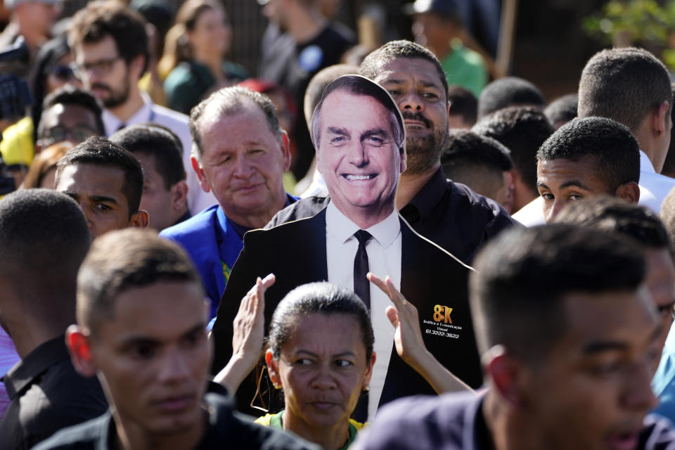 Supporters carry a life-size image of Brazil's President Jair Bolsonaro during a campaign rally in the rural workers' settlement Nova Jerusalem, or New Jerusalem, in Brasilia, Brazil, Monday, Oct. 24, 2022. Bolsonaro is running for reelection in the presidential runoff election set for Oct. 30. (AP Photo/Eraldo Peres)