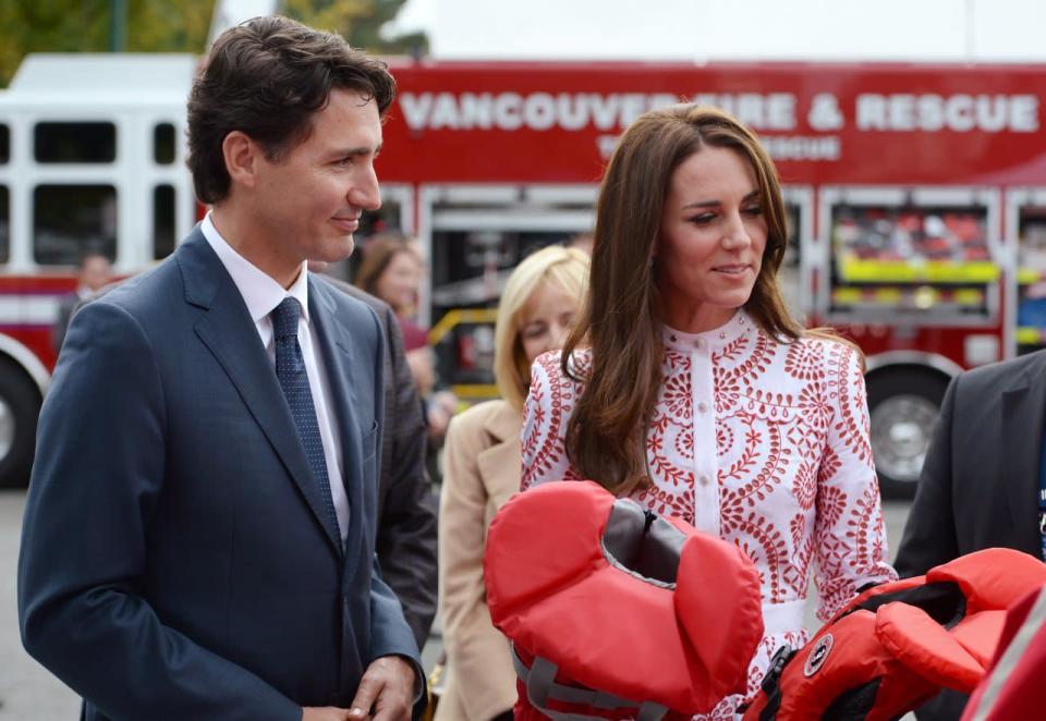 The Duchess of Cambridge receives a gift of two kid’s sized personal floatation devices during a walk at the Kitsilano Coast Guard station with Prime Minister Justin Trudeau, in Vancouver on Sunday, Sept. 25, 2016. THE CANADIAN PRESS/Jonathan Hayward