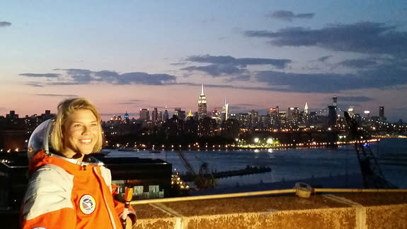 NASTAR space training center director Brienna Henwood, clad in a Final Frontier Design spacesuit, poses for photos with the New York City skyline as a backdrop during Final Frontier Design's Spacesuit Experience launch party on Aug. 28, 2014. T