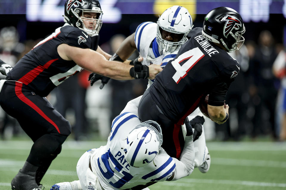 Indianapolis Colts defensive end Kwity Paye (51) tackles Atlanta Falcons quarterback Taylor Heinicke (4) during the first half of an NFL football game, Sunday, Dec. 24, 2023, in Atlanta. (AP Photo/Alex Slitz)