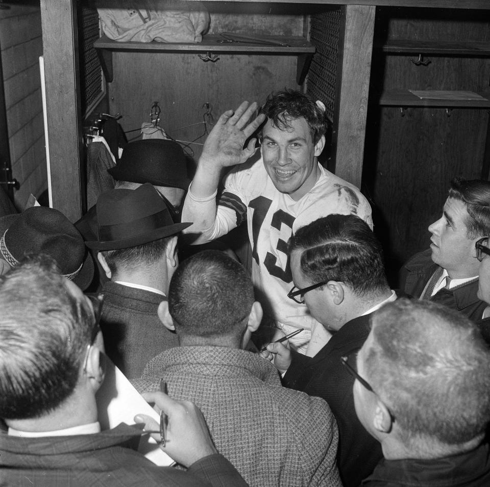 Quarterback Frank Ryan of the Cleveland Browns salutes in dressing room Dec. 27, 1964, in Cleveland after his three touchdown passes to Gary Collins help lift the Browns over the Baltimore Colts in the NFL title game.