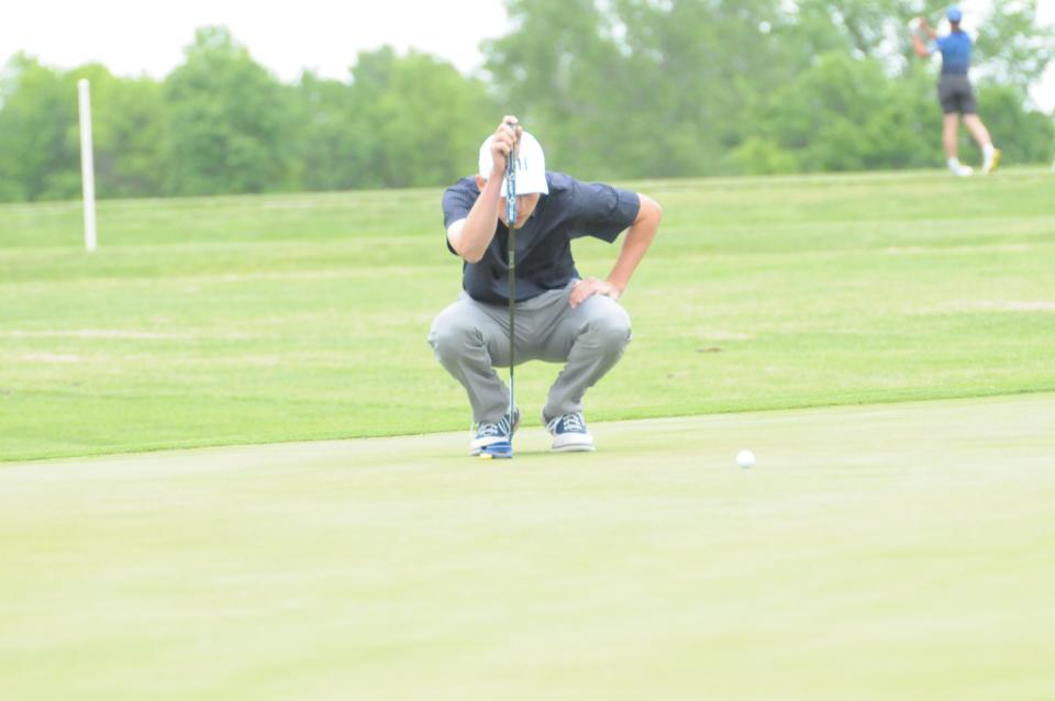 Sacred Heart's Michael Matteucci figures out his putt during the Class 2A state golf championships Monday, May 23 2022 at Emporia Municipal Golf Course.