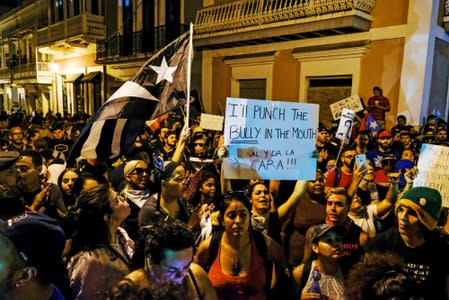 Demonstrators chant aduring the fourth day of protest calling for the resignation of Governor Ricardo Rossello in San Juan