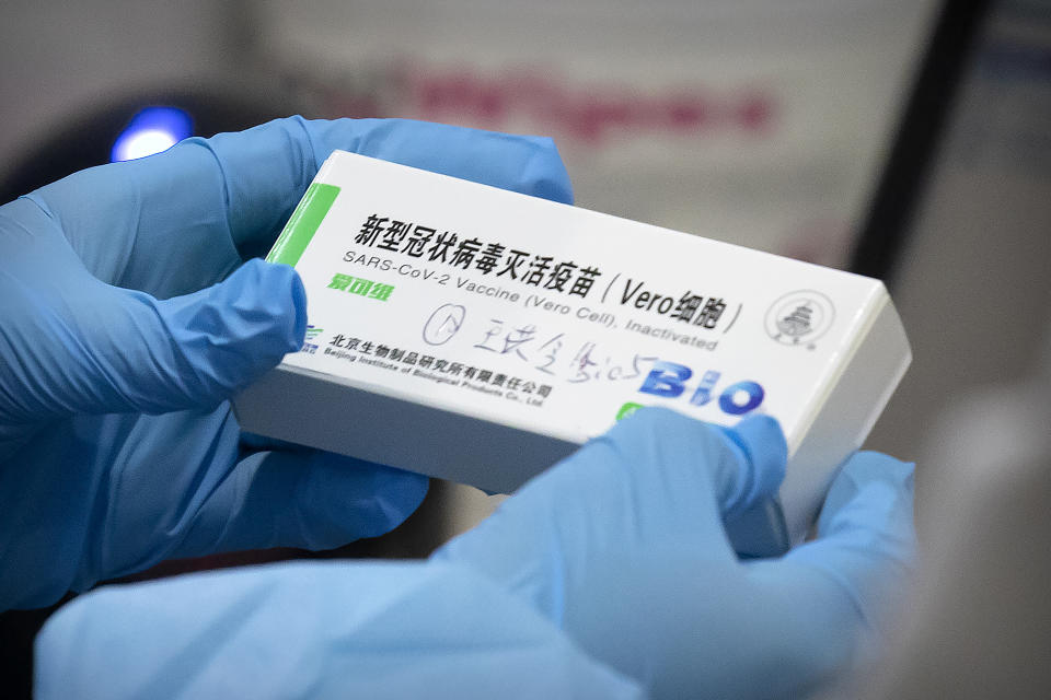 A medical worker holds a package for a Sinopharm vaccine at a vaccination facility in Beijing on Jan. 15, 2021. Two vaccines made by China’s Sinopharm appear to be safe and effective against COVID-19, according to a study published in a medical journal. Scientists have been waiting for more details about the two vaccines, even though they already are being used in many countries and one recently won the backing of the World Health Organization. (AP Photo/Mark Schiefelbein)