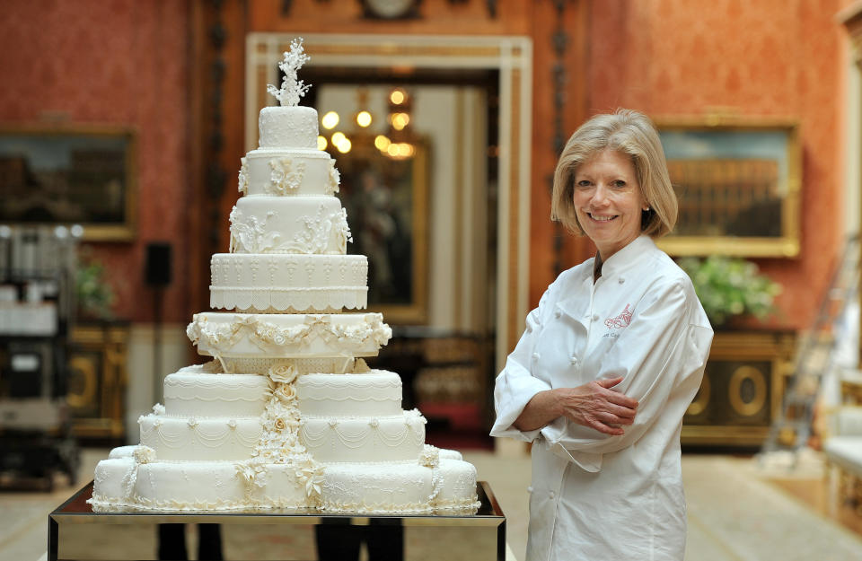 Fiona Cairns stands next to the wedding cake she and her team made for Prince William and Kate Middleton.  (Photo: JOHN STILLWELL via Getty Images)