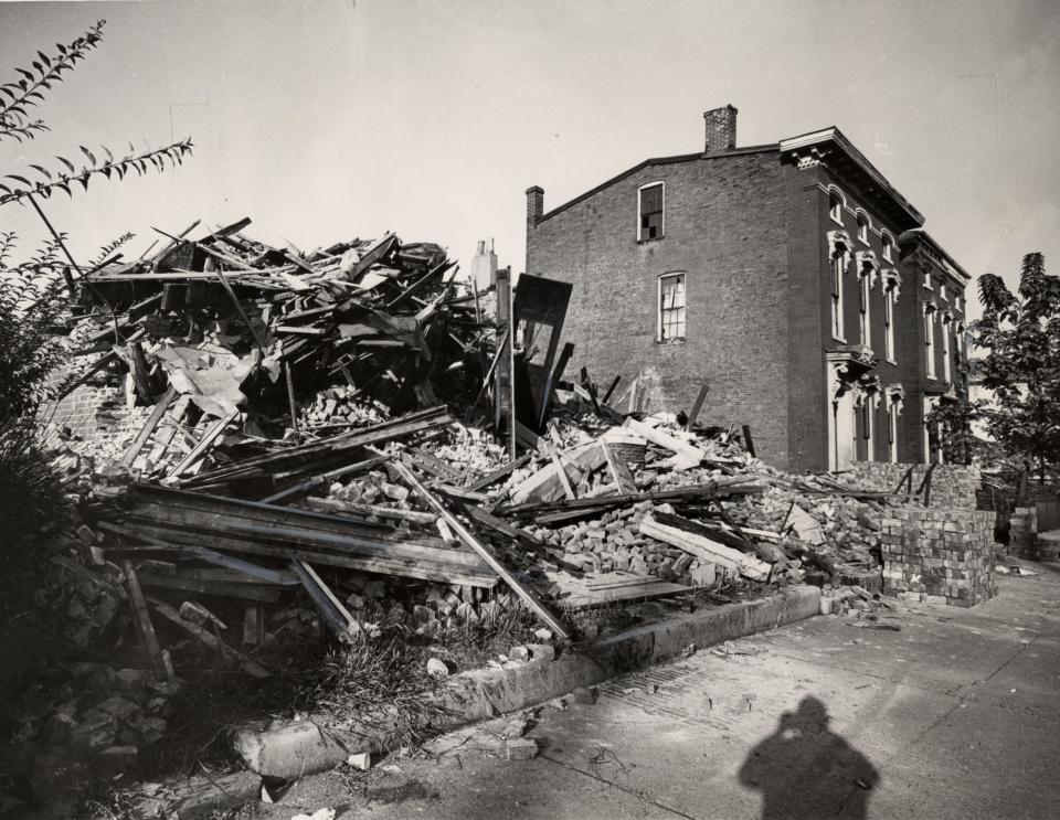 Sept. 25, 1963 - Another heap of rubble tells the progress story at 1423 W. Chestnut as razing precedes renewal. Windows are broken in the next house to go.