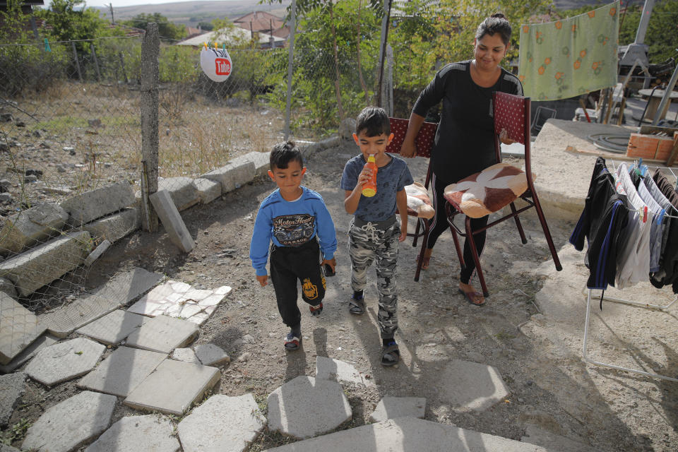 Bulgarian Roma children of the Topchu family walk in a village on the outskirts of Burgas, Bulgaria, Monday, Sept. 28, 2020. (AP Photo/Vadim Ghirda)