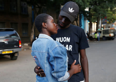 Tony Wakaiga, 18, an art and design student and Suzzy Konje, 18, a hospitality management student pose for a photograph after their date as they walk along Banda Street in Nairobi, Kenya, February 11, 2018. Tony met Suzzy at a modelling photo session on Banda Street and they soon started dating. "We have been very good friends for a long time and our passion for each other has matured like wine. This Valentine's Day, I have a special surprise for Suzzy that will knock her heart out," said Tony. REUTERS/Thomas Mukoya