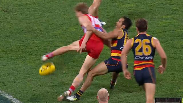 Betts brings down Mills after he plays on. Pic: Fox Footy