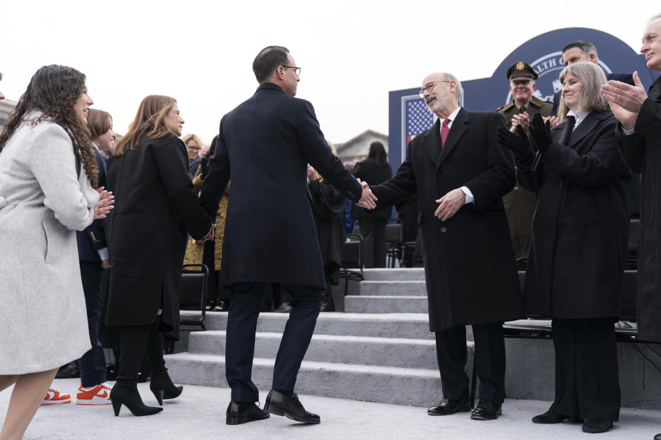 Democratic Gov. Josh Shapiro, center left, shakes hands with former Gov. Tom Wolf after becoming Pennsylvania's 48th governor during an Inauguration ceremony, Tuesday, Jan. 17, 2023, at the state Capitol in Harrisburg, Pa. (AP Photo/Matt Rourke)