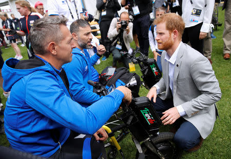 Britain's Prince Harry talks to Italian athletes during the Invictus Games at the Royal Botanic Garden in Sydney, Australia October 21, 2018. REUTERS/Phil Noble