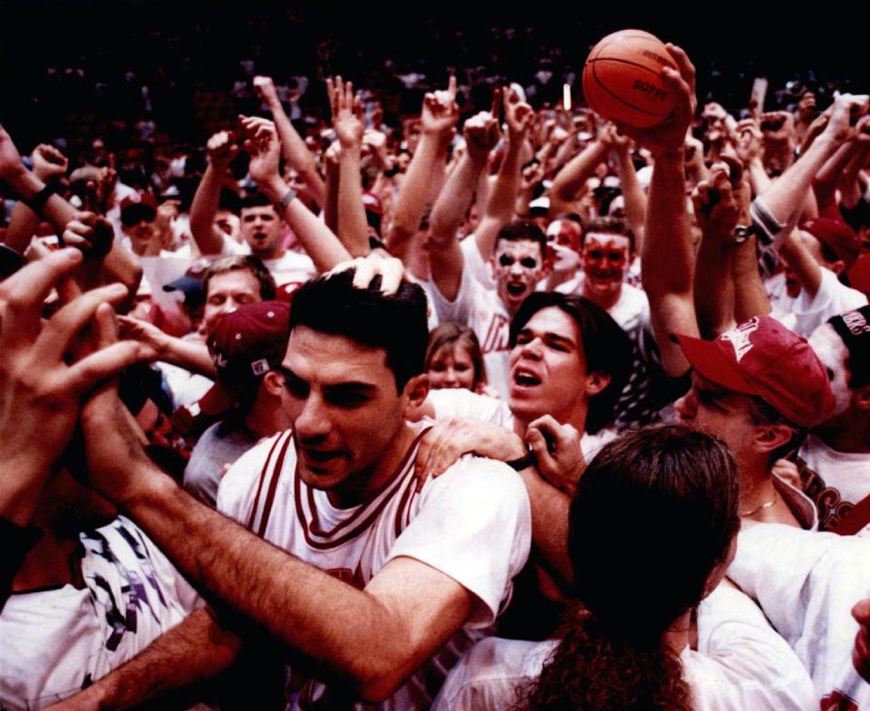 OU basketball star Ryan Minor is mobbed by fans after a Sooners win in 1995 at Lloyd Noble Center in Norman.