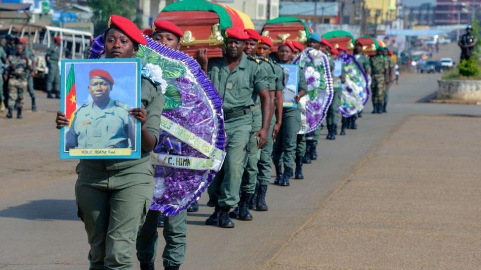 Soldiers carry the coffins of the four soldiers killed in the violence that erupted in the Northwest and Southwest Regions of Cameroon, where most of the country's English-speaking minority live, during a ceremony in Bamenda