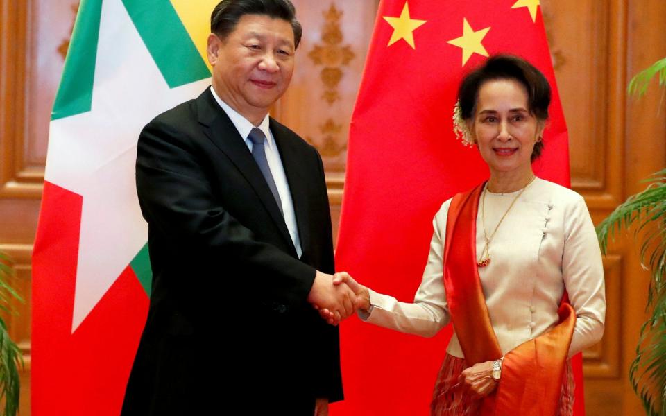 Xi Jinping is on a trade visit to Aung San Suu Kyi in Burma - REUTERS