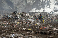 A trash collector searches for recyclable material at the landfill near Priboj, in southwest Serbia, Friday, Jan. 22, 2021. Serbia and other Balkan nations are virtually drowning in communal waste after decades of neglect and lack of efficient waste-management policies in the countries aspiring to join the European Union. (AP Photo/Darko Vojinovic)