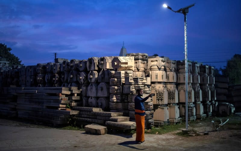 A devotee takes selfie with the pillars that Hindu nationalist group Vishva Hindu Parishad (VHP) say will be used to build a Ram temple at the disputed religious site in Ayodhya