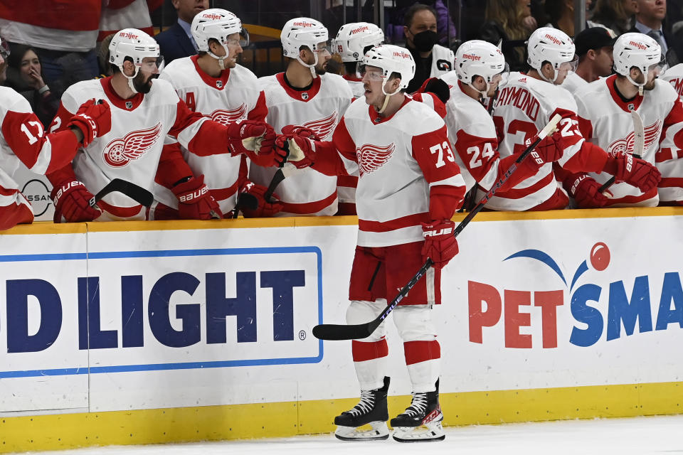 Detroit Red Wings left wing Adam Erne (73) is congratulated after scoring a goal against the Nashville Predators during the second period of an NHL hockey game Saturday, Jan. 22, 2022, in Nashville, Tenn. (AP Photo/Mark Zaleski)