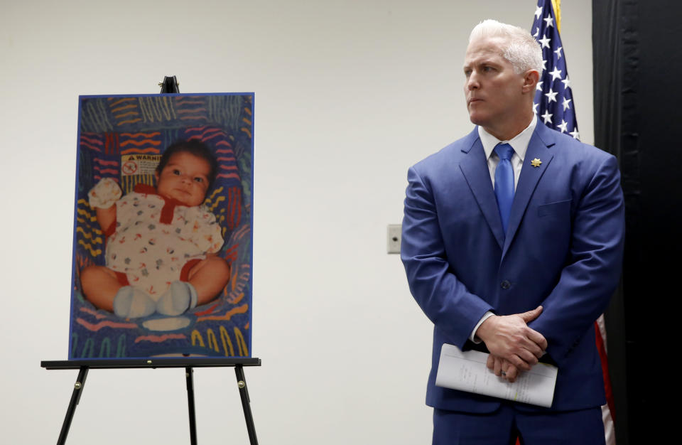 Yolo County District Attorney Jeff Reisig stands next to a photo of Kato Krow Perez, born in 2001. Kato was one of five infants believed to have been killed by their father. (Photo: ASSOCIATED PRESS)