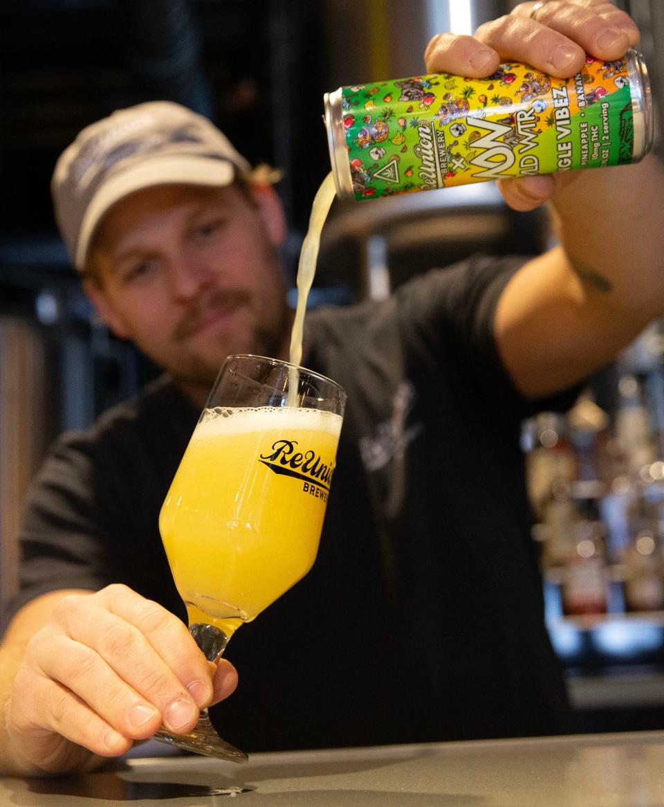 ReUnion brewer Logan DePover pours a sample of ReUnion Brewery and WLD WTR's new THC beverage, Jungle Vibez, Monday, Jan. 22, 2024 at ReUnion's downtown Iowa City, Iowa, location.