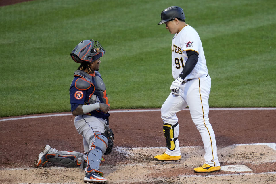 Pittsburgh Pirates' Ji Man Choi, right, steps on home plate after hitting a solo home run off Houston Astros starting pitcher Framber Valdez (not shown) during the second inning of a baseball game in Pittsburgh, Monday, April 10, 2023. (AP Photo/Gene J. Puskar)