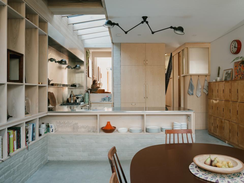 “In terms of the spatial planning, the classic thing is to have a train track arrangement with your kitchen and an island and a dining table all parallel to the length of the house, which can often make it feel like this series of very narrow spaces, all running through to the garden,” says Daniel Goodacre, cofounder of DGN Studio. “We wanted to create this U-shaped kitchen in the center of the plan, so it’s a bit more like different episodes as you move through the space.”