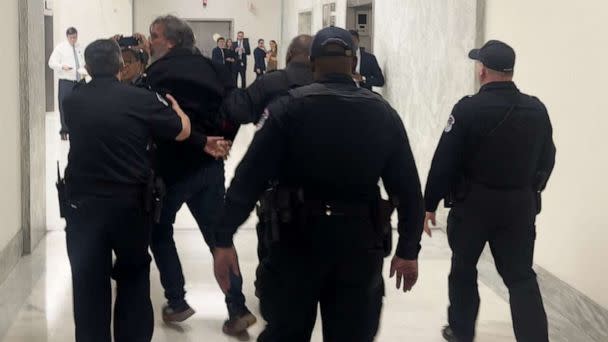 PHOTO: In this screen grab from a video, Manuel Oliver walked away in handcuffs after being arrested outside an Oversight Committee hearing at the U.S. Capitol in Washington, D.C., on March 23, 2023. (Will Steakin/ABC News)