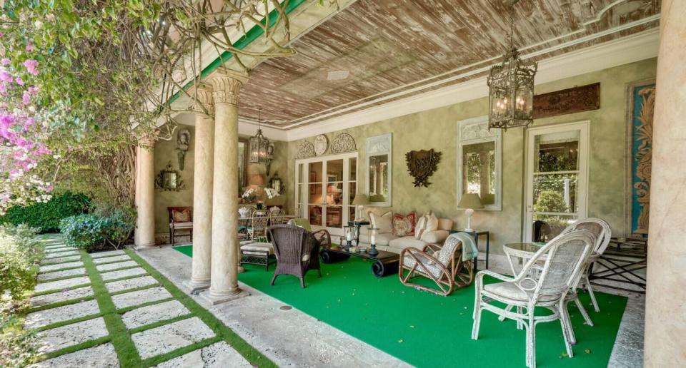 The covered loggia at 960 N. Ocean Blvd. in Palm Beach has a pecky-cypress ceiling.