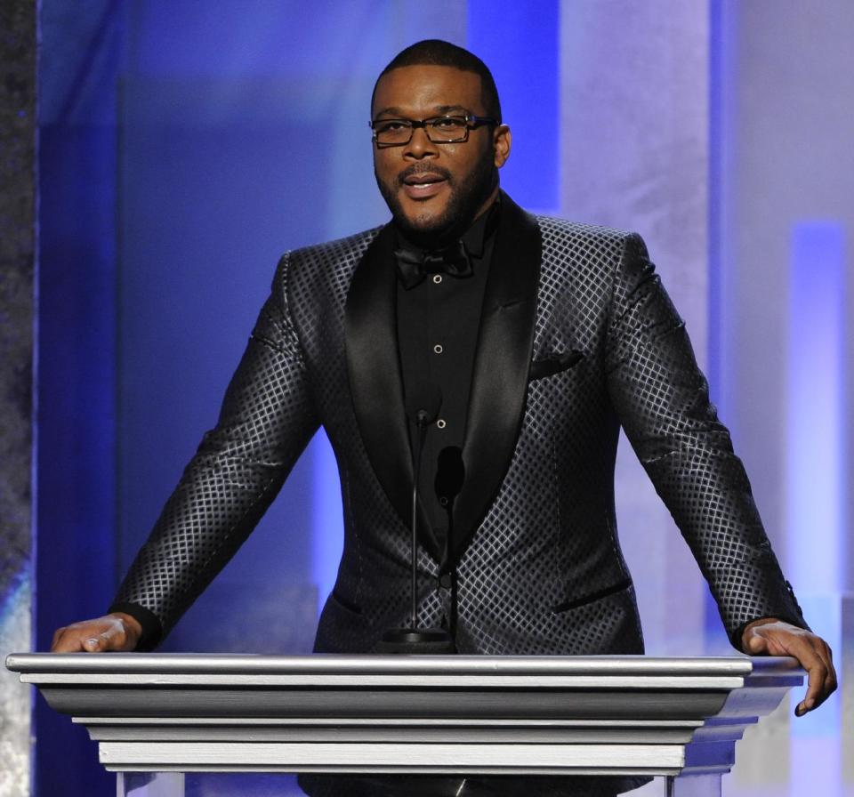 File-This Feb. 22, 2014, file photo shows Tyler Perry speaking on stage at the 45th NAACP Image Awards at the Pasadena Civic Auditorium in Pasadena, Calif. Perry reminded black filmmakers that there is “more than one path” as he implored them to find alternatives to getting films made at an event honoring black men in Hollywood. Perry was among those honored by Essence at a celebration held at his own mansion on Wednesday, Feb. 26, 2014. Others honored included Spike Lee, Malcolm Lee (director of the “Best Man” films) and Sidney Poitier, who gave a moving speech that in part paid tribute to black actors who opened the doors for future generations. (Photo by Chris Pizzello/Invision/AP, File)