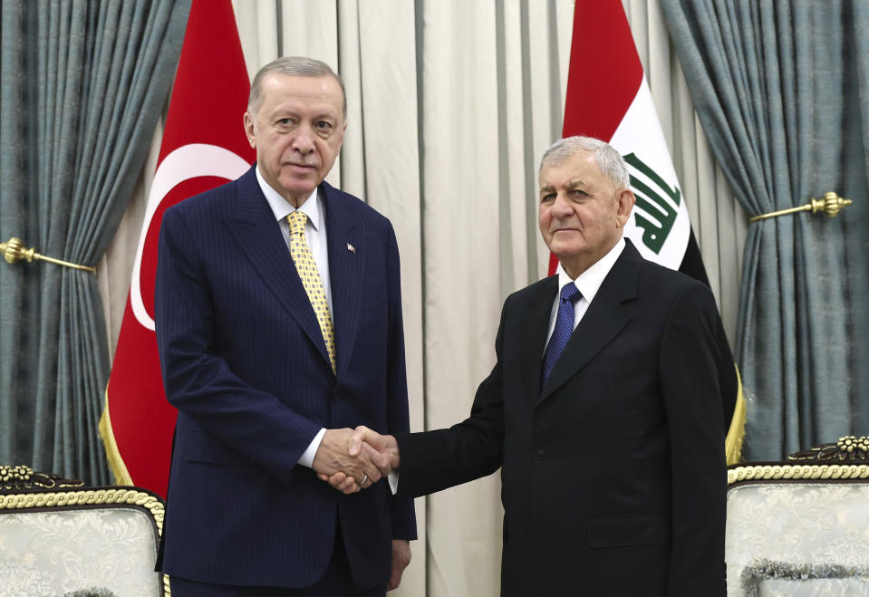 Iraqi President Abdul Latif Rashid, right, and Turkish President Recep Tayyip Erdogan shake hands in Baghdad, Iraq, Monday April 22, 2024. (Turkish Presidency via AP)