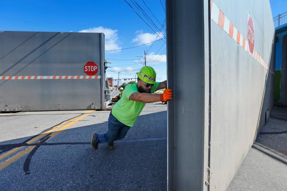 Luis Bula opens one of the massive hurricane barrier doors during the annual New Bedford DPI inspection of the hurricane barrier doors on Cove Road, and other sites throughout the city, in preparation for hurricane season.