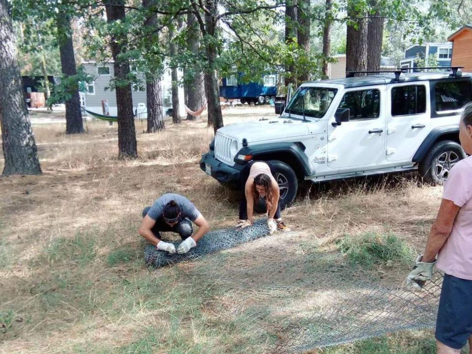 two people working on fixing something