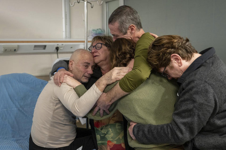 Hostage Luis Har, left, is hugged by relatives after being rescued from captivity in the Gaza Strip, at the Sheba Medical Center in Ramat Gan, Israel, Monday, Feb. 12, 2024. Israeli forces rescued two hostages early Monday, storming a heavily guarded apartment in the Gaza Strip and extracting the captives under fire in a dramatic raid that was a small but symbolically significant success for Israel. Marman was taken hostage by Hamas in cross-border attack in October last year. (Israeli Army via AP)