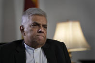 FILE- Sri Lanka's new prime minister Ranil Wickremesinghe gestures during an interview with The Associated Press in Colombo, Sri Lanka, June 11, 2022. Wickremesinghe told Parliament on Wednesday that Sri Lanka’s economy has collapsed after months of shortages of food, fuel and electricity. (AP Photo/Eranga Jayawardena, File)