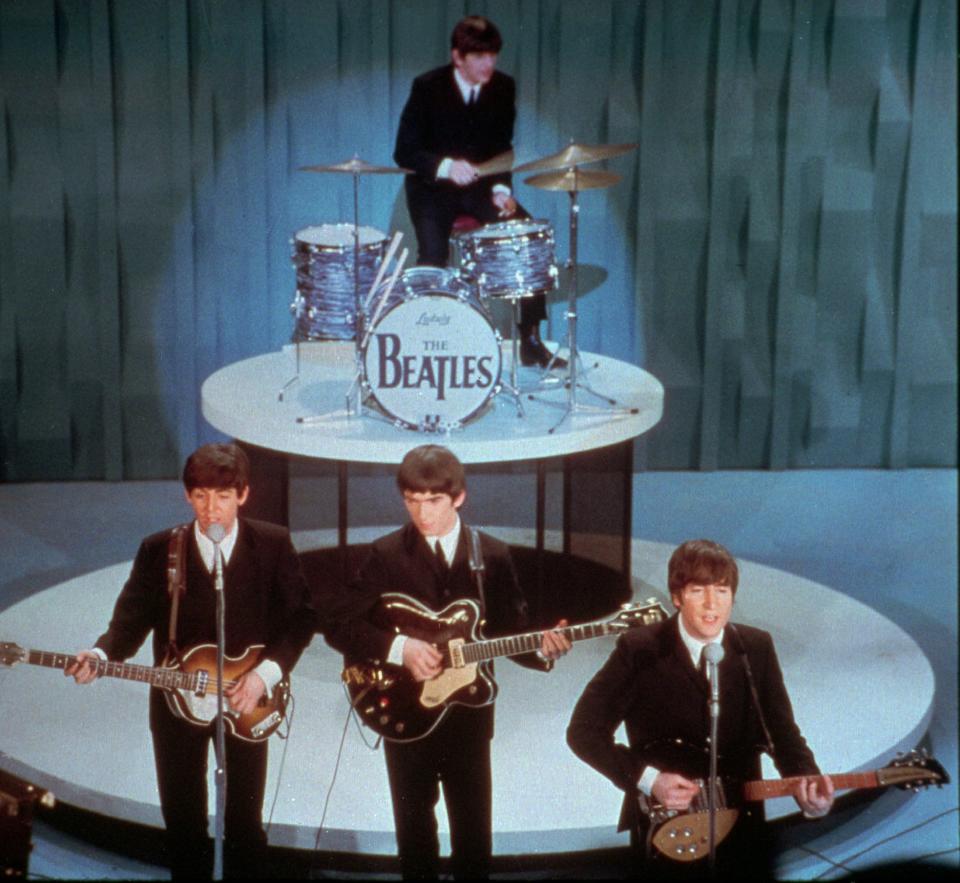 FILE - The Beatles perform at the "Ed Sullivan Show," in New York in this Feb. 9, 1964 file photo. Universal Music Group can buy the famed British music company EMI, including the hugely lucrative Beatles catalogue, the European Union's competition regulator said Friday Sept 21 2012, but must jettison some of the famed label’s other big acts, including Coldplay and Pink Floyd. (AP Photo)