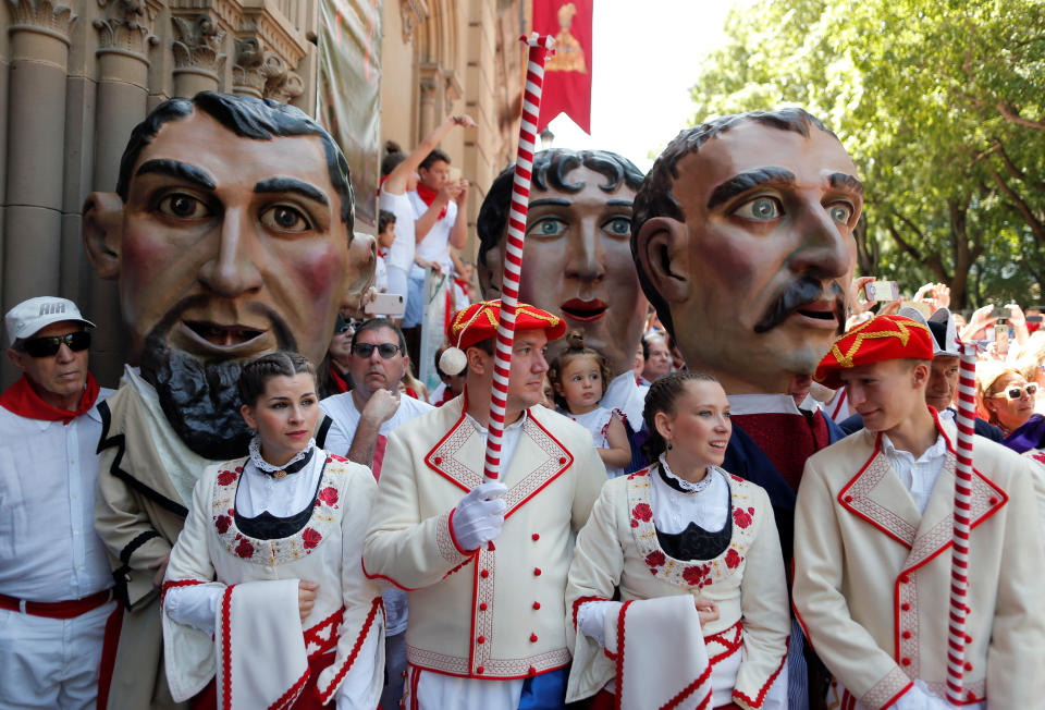 "Cabezudos" (Big heads) and dancers take part in a procession of the Saints Day after the first running of the bulls at the San Fermin festival in Pamplona, Spain, July 7, 2019. (Photo: Jon Nazca/Reuters)