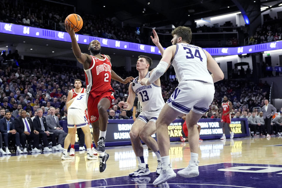 Ohio State guard Bruce Thornton (2) drives to the basket against Northwestern guard Brooks Barnhizer (13) and center Matthew Nicholson (34) during the first half of an NCAA college basketball game in Evanston, Ill., Saturday, Jan. 27, 2024. (AP Photo/Nam Y. Huh)