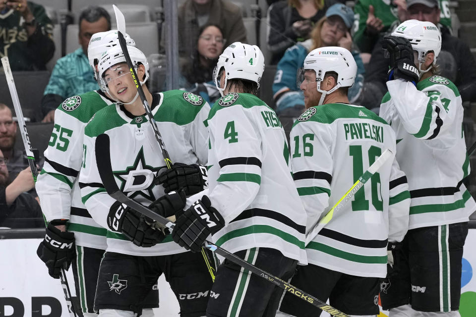 FILE - Dallas Stars left wing Jason Robertson, second from left, is congratulated by teammates for his goal against the San Jose Sharks during the second period of an NHL hockey game in San Jose, Calif., Tuesday, March 26, 2024. The Stars are heading toward the NHL playoffs with the league's most balanced scoring team. (AP Photo/Jeff Chiu, File)