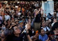 Supporters record with their phones at a sudden unauthorised rally by the progressive Future Forward Party in Bangkok