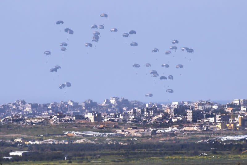 A U.S. Air Force C-130 drops humanitarian aid by parachute over the Gaza Strip on Sunday. Airdrops of aid have been condemned by the Hamas-run administration of Gaza as "useless" in the face of the scale of the task of getting humanitarian supplies to the 2.4 million people in the strip who are in desperate need of water and food.

Photo by Jim Hollander/UPI