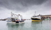 French fishing vessels block the port of St Helier in Jersey, Thursday, May 6, 2021. French fishermen angry over loss of access to waters off their coast have gathered their boats in protest off the English Channel island of Jersey. The head of a grouping of Normandy fishermen said about 50 boats from French ports joined the protest Thursday morning and gathered their fleet off the Jersey port of St. Helier. (Gary Grimshaw/Balliwick Express via AP)