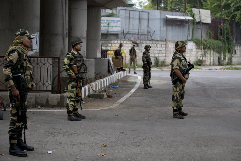 Border Security Force soldiers stand guard at a temporary check post during curfew in Srinagar, Indian controlled Kashmir, Wednesday, Aug. 7, 2019. Authorities in Hindu-majority India clamped a complete shutdown on Kashmir as they scrapped the Muslim-majority state's special status, including exclusive hereditary rights and a separate constitution, and divided it into two territories. (AP Photo/Dar Yasin)