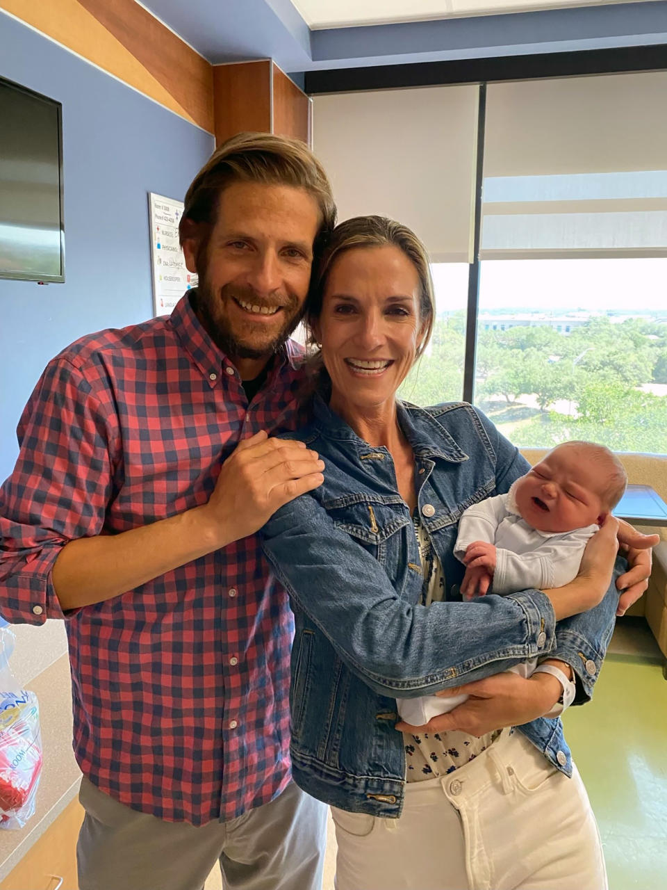 Adoptive parents hold their new baby. (Courtesy Madelynn Ballenger)