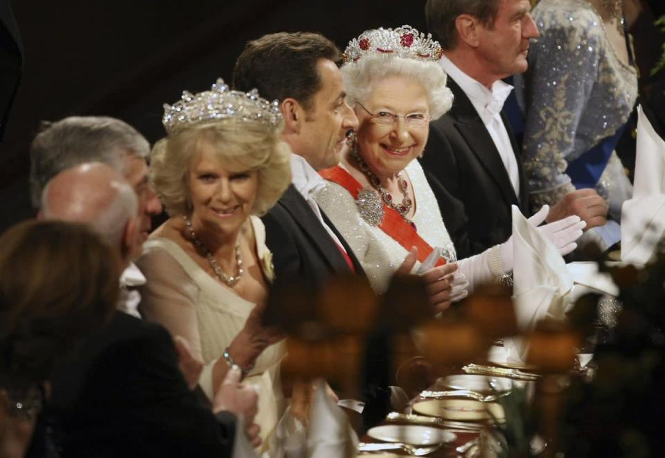 Camilla, seated next to France’s then president Nicolas Sarkozy, and close to the Queen at a state banquet (Matt Dunham/PA) (PA Wire)