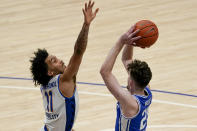 Pittsburgh's Justin Champagnie (11) defends as Duke's Matthew Hurt shoots during the second half of an NCAA college basketball game, Tuesday, Jan. 19, 2021, in Pittsburgh. Pittsburgh won 79-73. (AP Photo/Keith Srakocic)