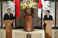 China' Foreign Minister Wang Yi, left, and his Japanese counterpart Toshimitsu Motegi participate in a press briefing in Tokyo on Tuesday, Nov. 24, 2020. Wang met Motegi on Tuesday to discuss ways to revive their pandemic-hit economies as well as regional concerns over China’s growing influence. (Issei Kato/Pool Photo via AP)