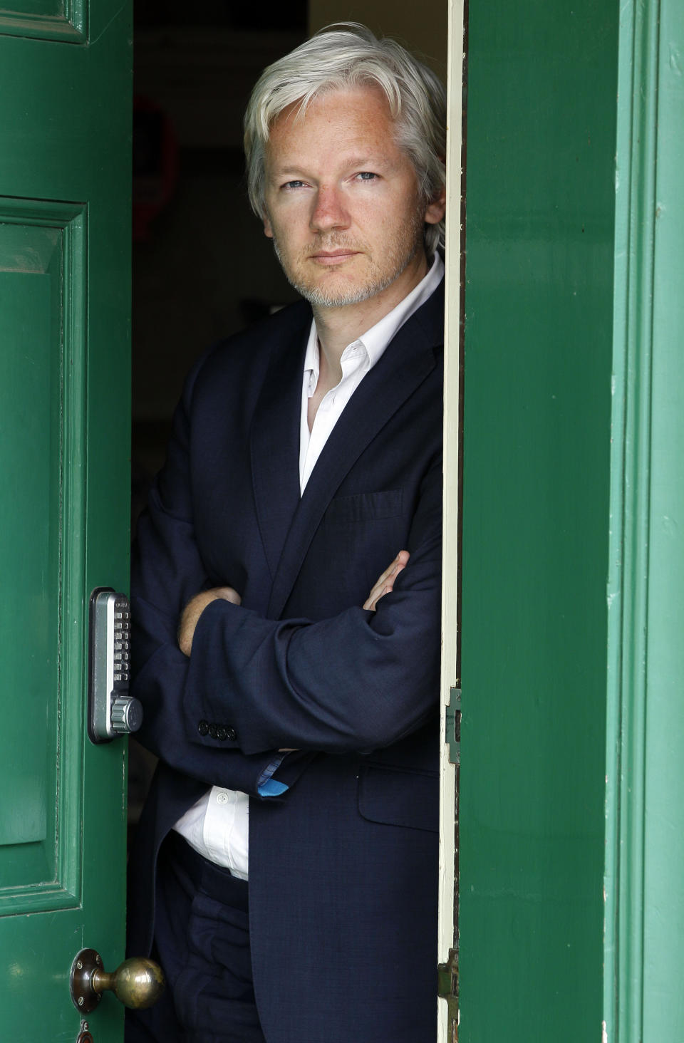 FILE - In this Wednesday, June 15, 2011 file photo, WikiLeaks founder Julian Assange is seen at the house where he is required to stay in, near Bungay, England. Police in London arrested WikiLeaks founder Assange at the Ecuadorean embassy Thursday, April 11, 2019 for failing to surrender to the court in 2012, shortly after the South American nation revoked his asylum. (AP Photo/Kirsty Wigglesworth, File)