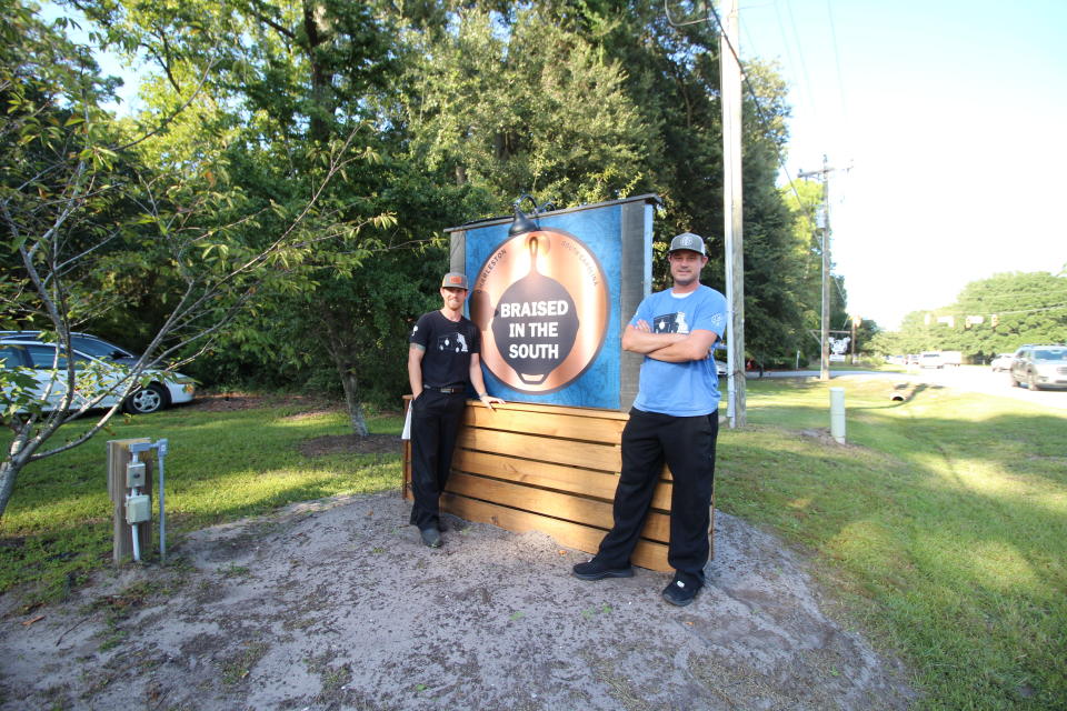 This photo provided by Hannah Albert on Sept. 23, 2020 shows Steve Klatt, left, and Brandon Lapp, owners of Braised in the South, a Johns Island, S.C, restaurant and food truck business that is having trouble finding workers during the pandemic. Many small businesses find hiring more difficult because many would-be staffers fear contracting COVID-19 on the job or would prefer to live off unemployment benefits. (Hannah Albert via AP)