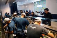 Workers prepare orders in the kitchen at a Chopt Creative Salad Co., location in New York