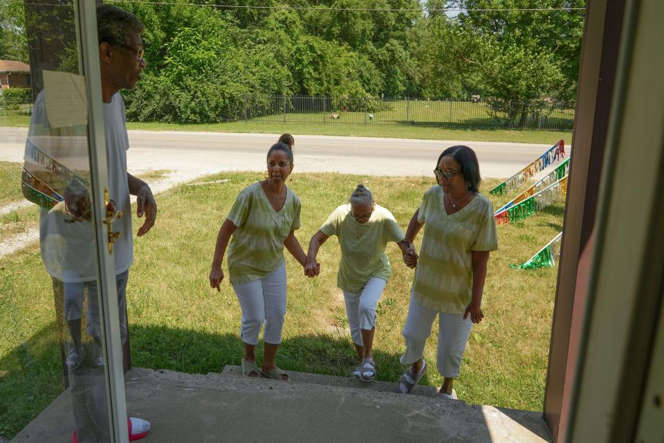 Lawrence McReynolds, 67, left, holds the door open for Ellen Cavanaugh, 63, left, and Jerri McReynolds, 65, right, as they walk their Mother Esther Williams outside for her 90th birthday celebration on Wednesday, June 22, 2022, in Indianapolis.