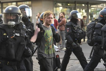 German riot police officers detain a protester during demonstrations at the G20 summit in Hamburg, Germany, July 8, 2017. REUTERS/Fabian Bimmer